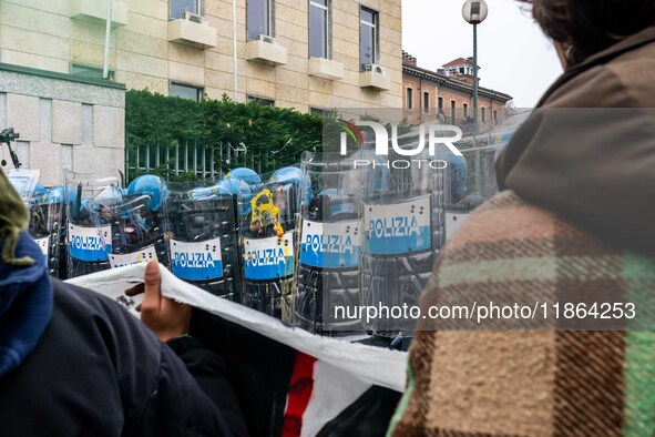 During a student march, a clash occurs in front of the Polytechnic University in Turin, Italy, on December 13, 2024. The students attempt to...