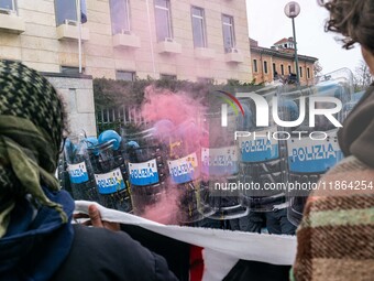 During a student march, a clash occurs in front of the Polytechnic University in Turin, Italy, on December 13, 2024. The students attempt to...