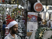 A man wears a Santa Claus cap at a market ahead of the Christmas celebrations in Mumbai, India, on December 13, 2024. (