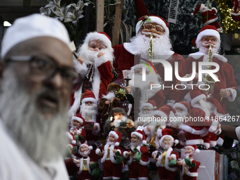 Santa Claus items are seen in a shop at a market ahead of the Christmas celebrations in Mumbai, India, on December 13, 2024. (