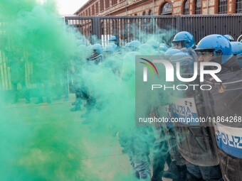 During a student march, a clash occurs in front of the Polytechnic University in Turin, Italy, on December 13, 2024. The students attempt to...