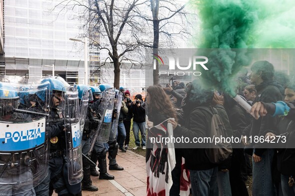 During a student march, a clash occurs in front of the Polytechnic University in Turin, Italy, on December 13, 2024. The students attempt to...