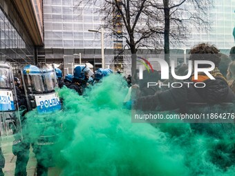 During a student march, a clash occurs in front of the Polytechnic University in Turin, Italy, on December 13, 2024. The students attempt to...