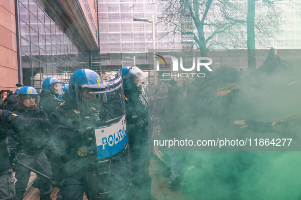 During a student march, a clash occurs in front of the Polytechnic University in Turin, Italy, on December 13, 2024. The students attempt to...