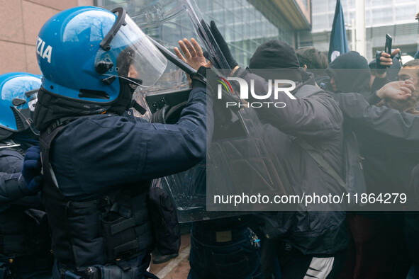 During a student march, a clash occurs in front of the Polytechnic University in Turin, Italy, on December 13, 2024. The students attempt to...