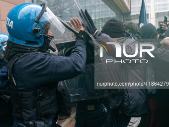 During a student march, a clash occurs in front of the Polytechnic University in Turin, Italy, on December 13, 2024. The students attempt to...