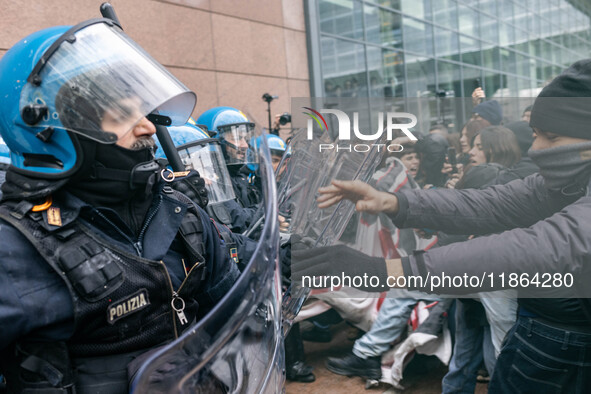 During a student march, a clash occurs in front of the Polytechnic University in Turin, Italy, on December 13, 2024. The students attempt to...