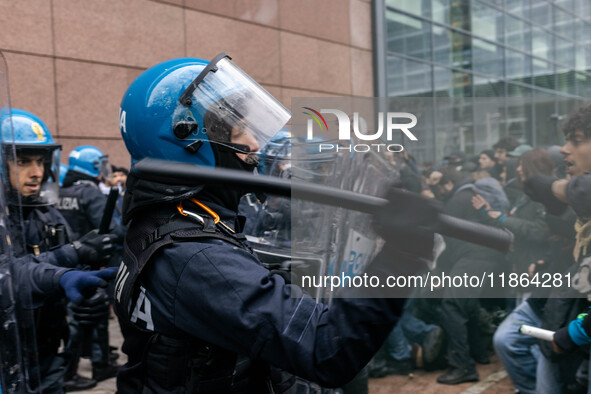 During a student march, a clash occurs in front of the Polytechnic University in Turin, Italy, on December 13, 2024. The students attempt to...