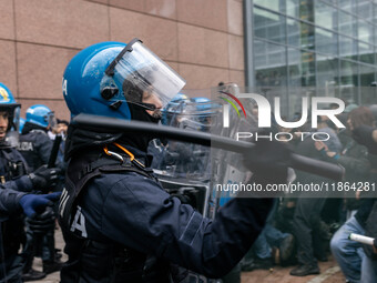 During a student march, a clash occurs in front of the Polytechnic University in Turin, Italy, on December 13, 2024. The students attempt to...