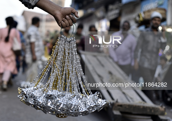 Shoppers walk past decorative items displayed at a market ahead of the Christmas celebrations in Mumbai, India, on December 13, 2024. 