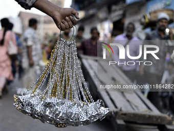 Shoppers walk past decorative items displayed at a market ahead of the Christmas celebrations in Mumbai, India, on December 13, 2024. (