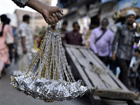 Shoppers walk past decorative items displayed at a market ahead of the Christmas celebrations in Mumbai, India, on December 13, 2024. (