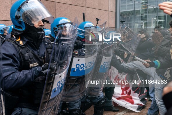 During a student march, a clash occurs in front of the Polytechnic University in Turin, Italy, on December 13, 2024. The students attempt to...