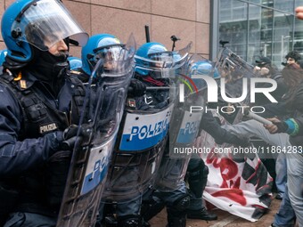 During a student march, a clash occurs in front of the Polytechnic University in Turin, Italy, on December 13, 2024. The students attempt to...