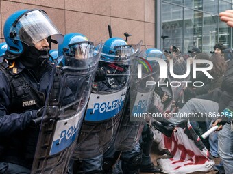 During a student march, a clash occurs in front of the Polytechnic University in Turin, Italy, on December 13, 2024. The students attempt to...