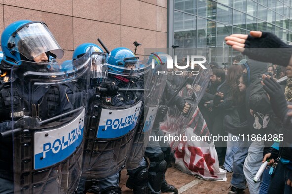 During a student march, a clash occurs in front of the Polytechnic University in Turin, Italy, on December 13, 2024. The students attempt to...