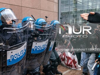 During a student march, a clash occurs in front of the Polytechnic University in Turin, Italy, on December 13, 2024. The students attempt to...