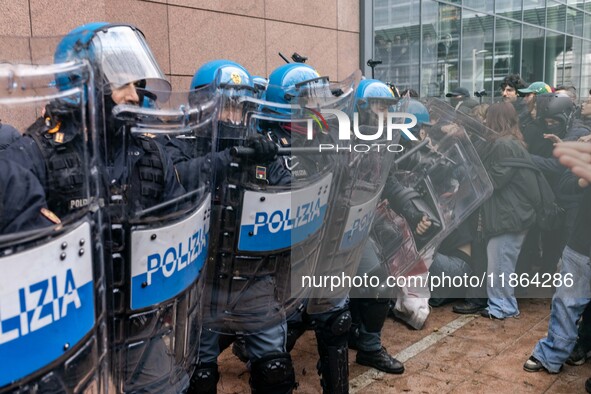 During a student march, a clash occurs in front of the Polytechnic University in Turin, Italy, on December 13, 2024. The students attempt to...