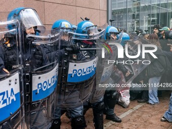 During a student march, a clash occurs in front of the Polytechnic University in Turin, Italy, on December 13, 2024. The students attempt to...