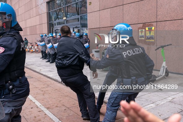 During a student march, a clash occurs in front of the Polytechnic University in Turin, Italy, on December 13, 2024. The students attempt to...