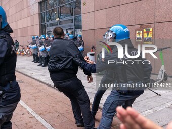 During a student march, a clash occurs in front of the Polytechnic University in Turin, Italy, on December 13, 2024. The students attempt to...