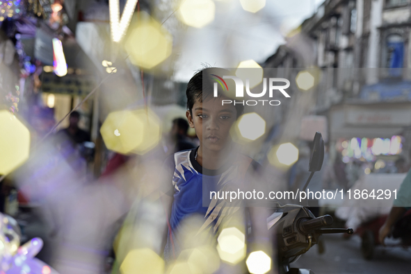 A boy sells fancy lights at a market ahead of the Christmas celebrations in Mumbai, India, on December 13, 2024. 