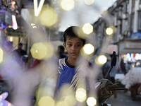 A boy sells fancy lights at a market ahead of the Christmas celebrations in Mumbai, India, on December 13, 2024. (