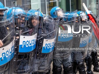 During a student march, a clash occurs in front of the Polytechnic University in Turin, Italy, on December 13, 2024. The students attempt to...