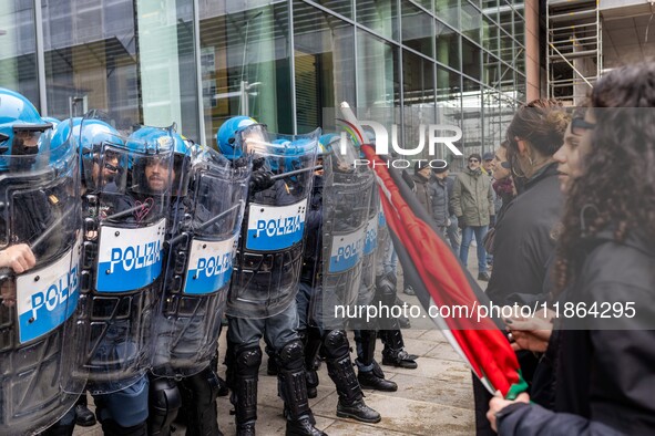 During a student march, a clash occurs in front of the Polytechnic University in Turin, Italy, on December 13, 2024. The students attempt to...