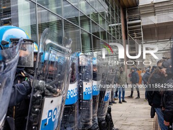 During a student march, a clash occurs in front of the Polytechnic University in Turin, Italy, on December 13, 2024. The students attempt to...