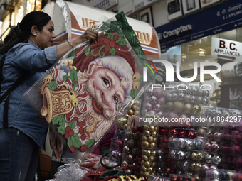 A customer browses Santa Claus stickers ahead of the Christmas celebrations in Mumbai, India, on December 13, 2024. (