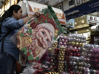 A customer browses Santa Claus stickers ahead of the Christmas celebrations in Mumbai, India, on December 13, 2024. (