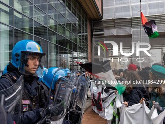 During a student march, a clash occurs in front of the Polytechnic University in Turin, Italy, on December 13, 2024. The students attempt to...