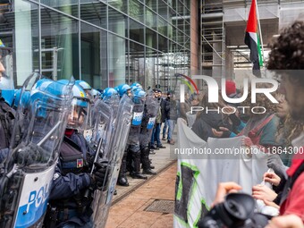 During a student march, a clash occurs in front of the Polytechnic University in Turin, Italy, on December 13, 2024. The students attempt to...