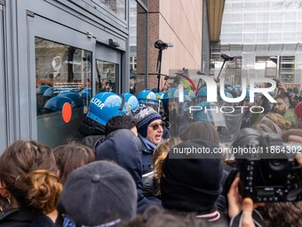 During a student march, a clash occurs in front of the Polytechnic University in Turin, Italy, on December 13, 2024. The students attempt to...