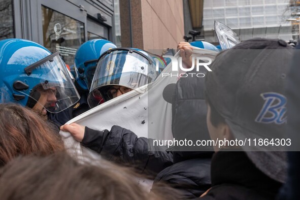 During a student march, a clash occurs in front of the Polytechnic University in Turin, Italy, on December 13, 2024. The students attempt to...