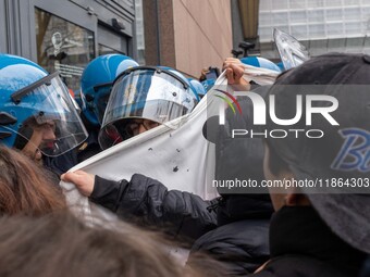 During a student march, a clash occurs in front of the Polytechnic University in Turin, Italy, on December 13, 2024. The students attempt to...