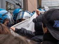 During a student march, a clash occurs in front of the Polytechnic University in Turin, Italy, on December 13, 2024. The students attempt to...