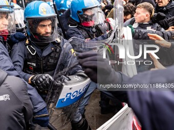 During a student march, a clash occurs in front of the Polytechnic University in Turin, Italy, on December 13, 2024. The students attempt to...