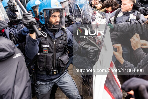 During a student march, a clash occurs in front of the Polytechnic University in Turin, Italy, on December 13, 2024. The students attempt to...