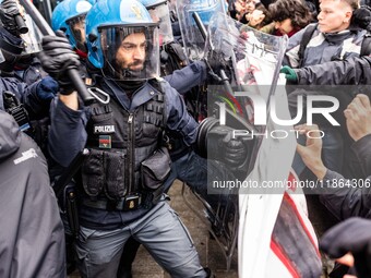 During a student march, a clash occurs in front of the Polytechnic University in Turin, Italy, on December 13, 2024. The students attempt to...