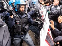 During a student march, a clash occurs in front of the Polytechnic University in Turin, Italy, on December 13, 2024. The students attempt to...