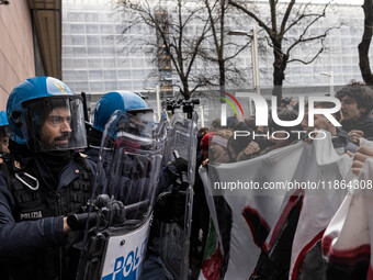 During a student march, a clash occurs in front of the Polytechnic University in Turin, Italy, on December 13, 2024. The students attempt to...