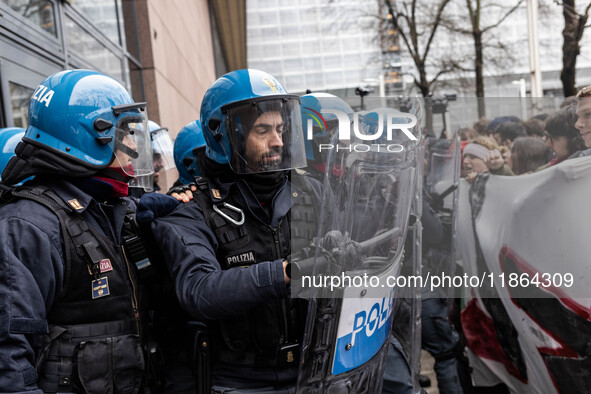 During a student march, a clash occurs in front of the Polytechnic University in Turin, Italy, on December 13, 2024. The students attempt to...