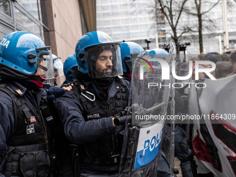 During a student march, a clash occurs in front of the Polytechnic University in Turin, Italy, on December 13, 2024. The students attempt to...