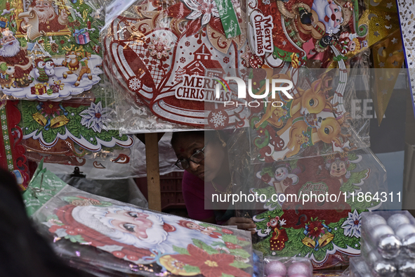 A woman sells stickers ahead of the Christmas celebrations in Mumbai, India, on December 13, 2024. 