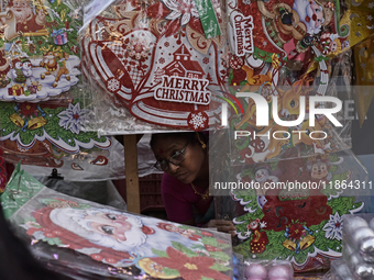 A woman sells stickers ahead of the Christmas celebrations in Mumbai, India, on December 13, 2024. (