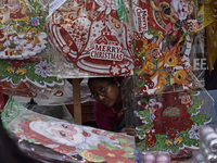 A woman sells stickers ahead of the Christmas celebrations in Mumbai, India, on December 13, 2024. (