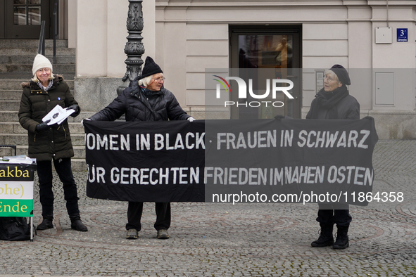 Women in Black hold a vigil at Gartnerplatz in Munich, Bavaria, Germany, on December 13, 2024, advocating for justice and peace in the Middl...