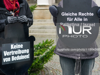 Women in Black hold a vigil at Gartnerplatz in Munich, Bavaria, Germany, on December 13, 2024, advocating for justice and peace in the Middl...